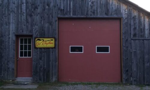 9_Shop for Banner July 2016 Rustic wooden building with slanted roof and two red doors